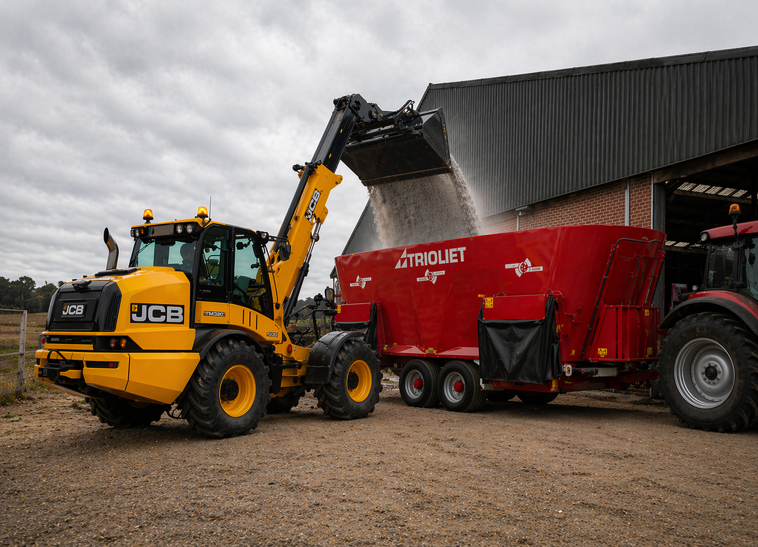 JCB telehandler loading a Trioliet feed mixer wagon on a UK dairy farm